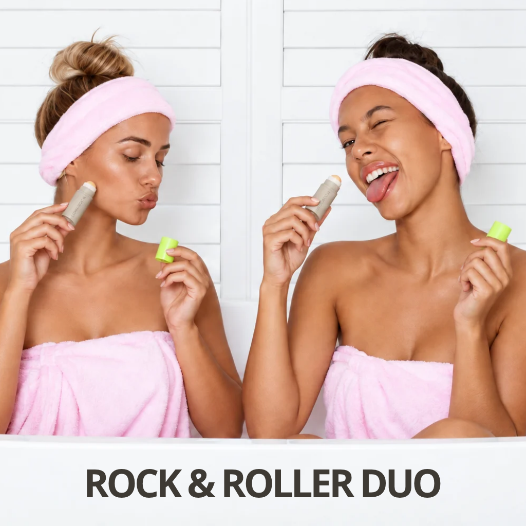 Two women wrapped in pink towels and wearing pink headbands demonstrate a product, holding small tubes and sticks in a bright bathroom setting. Text at the bottom reads 'ROCK & ROLLER DUO'.